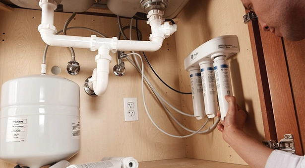 Under-sink reverse osmosis water filtration system installation process.